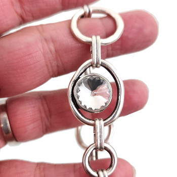 Clear crystal Swarovski crystal silver-plated toggle bracelet in my hand. 