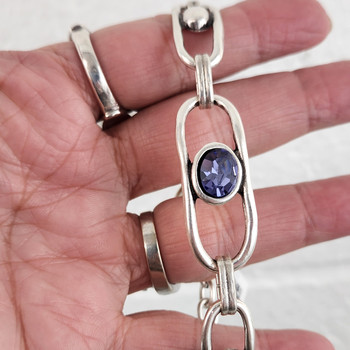 Purple Swarovski crystal silver-plated adjustable bracelet in my hand. 