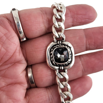 Gray Swarovski crystal silver-plated bracelet in my hand. 