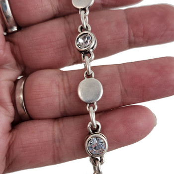 Clear Swarovski crystal silver-plated bracelet in my hand. 