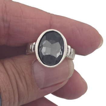 Gray oval crystal adjustable ring in my hand. 
