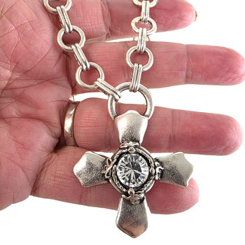 Iron cross clear crystal silver-plated necklace in my hand. 