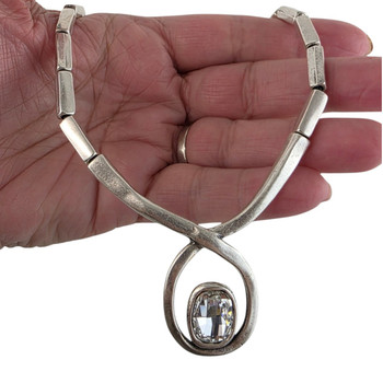 Gray tone crystal necklace with lobster claw in my hand. 