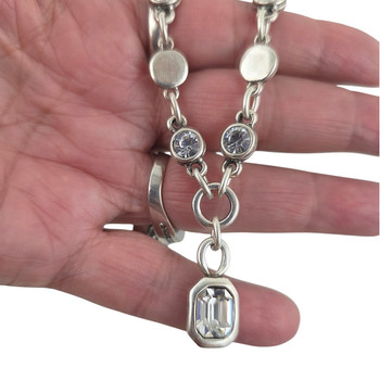 Clear crystal silver-plated necklace in my hand. 