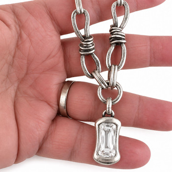 Clear crystal dangle necklace in my hand. 