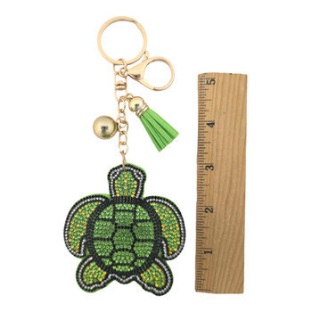 Green rhinestone turtle keychain with a ruler. 