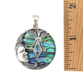 Moon and fairy pendant with paua shell and blue topaz stones with a ruler. 