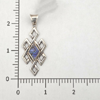 Paua shell geometric pendant with a ruler. 