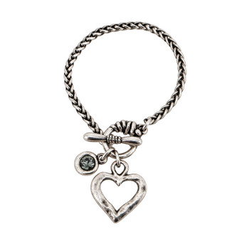 Silver-plated braided chain toggle bracelet with textured open heart charm, faceted gray crystal stone, and Pacific Northwest charm on a white background.