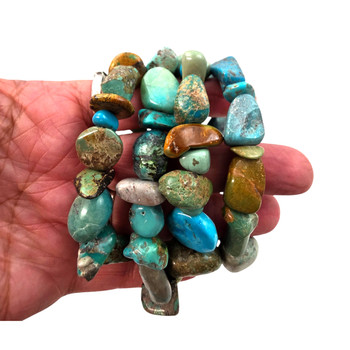 Extra large turquoise nugget elastic bracelets displayed in hand, highlighting oversized polished stones in beautiful blue, green, and earthy brown shades.
