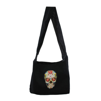 Black sling bag with colorful Day of the Dead skull on front of bag. 