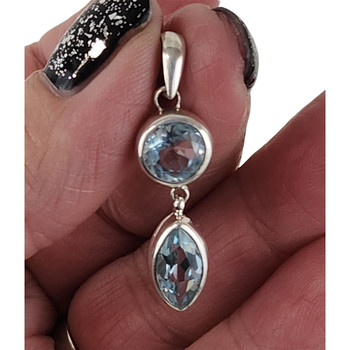 Blue Topaz sterling silver pendant in my hand. 