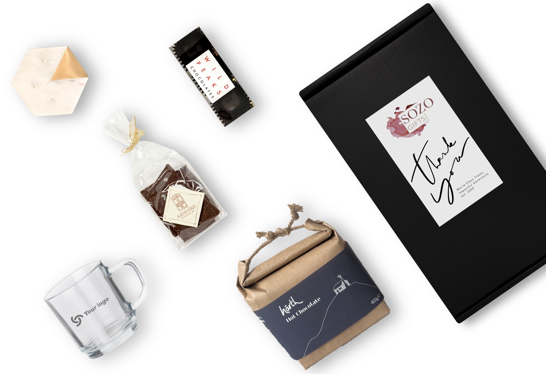 A unique and value-packed gift box with one mug engraved with your logo, one hexagonal marble coaster, one bag of salted dark chocolate by Wild Peaks, a trio of bonbons by Wild Peaks, and a 1 pound bag of artisan hot chocolate mix made by Harth in the UK.