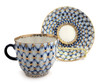 Cobalt Net Coffee Cup and Saucer. Cobalt net is the trademark style of the Lomonosov Porcelain Factory, which first appeared in 1949. The pattern is a combination of hand painted intersecting lines, or netting, of cobalt blue with inverted tear drops of cobalt blue (made from mineral cobalt) and 22 karat gold accents. Cup is 2½" high and 2¾" diameter. Saucer is 4½" diameter. Red ЛВЗ (LFZ) backstamp and "Made in USSR" in English, indicating pre-1991 manufacture.