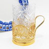 "Anna" Gold Plated Teaglass Holder.  Handmade delicate filigree podstakannik (подстаканник) was made in the village of Kazakovo. High quality filigree is reminiscent of lace work popularly known as "bobbin lace." 24Kt gold plate over copper. Comes with a Russian crystal glass. About 5" in height.