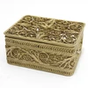 Golden Filigree Box. This elegant box was made entirely by hand, and not by a machine. It is a fine example of design and craftsmanship that was perfected in the days of Empress Catherine the Great (1762-1796). The pattern is reminiscent of bobbin-lace, and the artisans who created this style named it "Dew Drop" (in Russian, "Росинка"). It is hand decorated with tiny round pellets called "seed pearls" ("семенные жемчужины") and capped with a hand made rosette on the lid. Made the village of Kazakovo, near Nihzny Novgorod, a center of fine filigree work for decades. The box comes in it's original, Soviet-style box. 3"x2"x1¼".