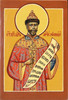 Holy martyred Tsar and passion-bearer Nicholas (Святой мученик, царь и страстотерпец Николай). On his scroll is a lengthy passage from Job 12:4 in Slavonic: "For a righteous and blameless man became a subject for mockery, for it had been ordained that he should fall under others at the appointed time, and that his house should be laid to waste by the lawless." The Blessed Martyr Nicholas wears an elaborate red robe, and is crowned with the golden Cap of Monomakh (шапка Мономаха), the symbol and crown of the Muscovite Grand Princes and Russian Tsars.