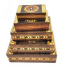 Set of 5 nested wooden Polish boxes. Crafted in Zakopane (Podhale region), a town which lies at the foothills of the Tatra Mountains. Each box is identically carved and stained with decorations incised using the techniques of the craft of traditional pyrography (woodburning). Boxes are lined with bright red felt (a nice touch), and nest perfectly within one another. The center of each box is a spiral flower with red and green enhancements and the surrounding wood is intricately textured. Three largest boxes have elaborate edge borders. An unusual set in brand new condition.