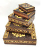 Set of 5 nested wooden Polish boxes. Crafted in Zakopane (Podhale region), a town which lies at the foothills of the Tatra Mountains. Each box is identically carved and stained with decorations incised using the techniques of the craft of traditional pyrography (woodburning). Boxes are lined with bright red felt (a nice touch), and nest perfectly within one another. The center of each box is a spiral flower with red and green enhancements and the surrounding wood is intricately textured. Three largest boxes have elaborate edge borders. An unusual set in brand new condition.