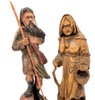 Peasant Couple, Poland. Detailed larger linden wood carvings of a man carrying a staff and a shoulder bag and a woman carrying a basket and a walking stick. His right foot rests on a rock. Both are dressed for mountain climbing. Written on the bottoms of each is "Poland 1992". This may indicate when they were purchased or when they were made. The style of the carvings appears to be older, perhaps somewhere post-WWII. Unusual, to say the least.
