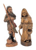 Peasant Couple, Poland. Detailed larger linden wood carvings of a man carrying a staff and a shoulder bag and a woman carrying a basket and a walking stick. His right foot rests on a rock. Both are dressed for mountain climbing. Written on the bottoms of each is "Poland 1992". This may indicate when they were purchased or when they were made. The style of the carvings appears to be older, perhaps somewhere post-WWII. Unusual, to say the least.