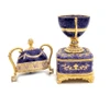 Faberge Serpent Clock Egg. A royal purple replica enamel egg of the original blue enamel egg, which was presented by Nicholas II to his mother, Maria Feodorovna, on Easter day, 1895. It features a "cercles tournants" (revolving dial) urn clock in the Louis XVI style with a snake to indicate the time. Currently, the original is owned by Prince Albert II, Prince Rainier III's son, and held in Monaco. 5¾" in height, 2" square base, slightly over 1 pound. Top half removes completely.