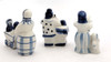 Set of three Gzhel figures including 1) Woman Reading a Newspaper (Женщина читает газету), 2) Woman Pushing a Baby Carriage (Женщина и коляска), and 3) Gossip (Сплетни). First two are from the 1970s from Turygino with backstamps, and third has a Gzhel backstamp indicative of later, post-Soviet breakup period. Sizes are 3¼", 2⅝" x 2½", and 3".