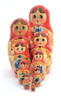 Golden Samovar Matryoshka (Матрешка Золотой самовар).  An early, fully handmade and painted 9-nest matryoshka dated 1990 and signed by the artist V. Lagutina (В. Лагутина). Her signature is in itself unusual, since USSR hadn't collapsed yet (it did at the end of 1991). Many of the vintage Russian matryoshkas from 1987 to 1999 found artists declining to sign their work due to old fears of engaging in "capitalist" endeavors (making a profit) and having a trail linked back to them. This was more pronounced in the bigger cities, where fear of reprisals was hard to shed completely.  The number of pieces in the set is also unusual and uncommon. The finished pieces are covered with a soft, smooth lacquer. The floral embellishments are disciplined and the samovar is filled in with "potal" ("поталь"), which is a form of gold foil decoration that imitates gilding. Atop the samovar, and eventually taking over, is a blue and white teapot painted in the Gzhel style. Even the dark handles are painted in. A real attractive set!