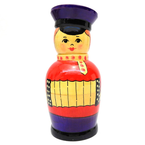 Kirov Lad with Bayan (Парень из Кирова с Баяном).  A classic country lad plays his bayan - a chromatic button accordion developed in Russia in the early 20th century and named after 11th-century bard Boyan. The purple service cap and collar are lathed from a single piece of wood.  USSR paper label in Russian. Made in the Kirov factory in the late 1980s. 5" in height.