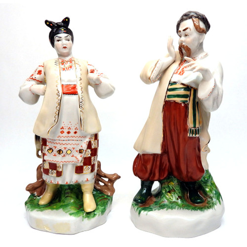 Ivan Karas and Odarka (Иван Карась и Одарка). Odarka defiantly takes issue with her Cossack husband, who perhaps has made a bit too much merry. Excellent details include the painted multi-color clothing and the modeling including the upside-down water jug on the fence post behind her. Kiev Experimental Art Ceramics Factory blue "Made in USSR" backstamp, circa 1979. Original design by Vladislav Ivanovich Shcherbina. Set of two, each 10" tall. Stamped in English for export. Book value for the pair runs about $200 and up.