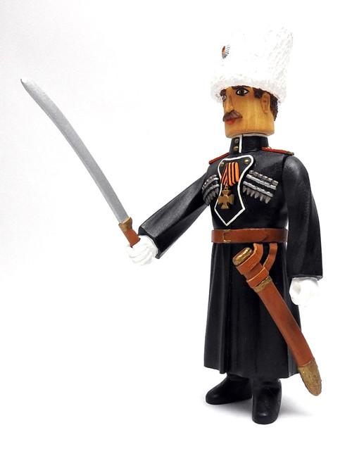 Beautifully detailed and painted carved figure dressed in the characteristic black uniform (cherkesska) of the Kuban Cossacks, made in Russia Beautifully detailed and painted carved figure dressed in the characteristic black uniform (cherkesska) of the Kuban Cossacks, made in Russia