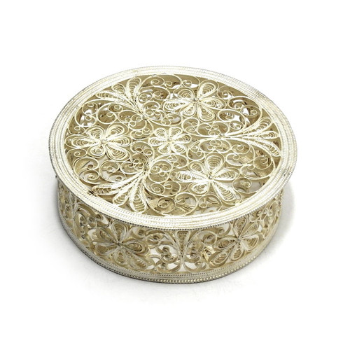 "Rose" (Роза) Round Box. Russian filigree boxes were made by hand and not a machine. This elegant round box is an outstanding example of filigree design and craftsmanship as perfected during the days of Catherine the Great, and can be used for potpourri. The pattern is reminiscent of bobbin-lace, decorated throughout with tiny seed pearls and dipped in near pure (99.9%) silver. Hand-crafted in Kazakavo, near Nihzny Novgorod (formerly the city of Gorky). 4"x 1¼". Comes in its own (retro Soviet-style) custom-fitted box. "Rose" (Роза) Round Box. Russian filigree boxes were made by hand and not a machine. This elegant round box is an outstanding example of filigree design and craftsmanship as perfected during the days of Catherine the Great, and can be used for potpourri. The pattern is reminiscent of bobbin-lace, decorated throughout with tiny seed pearls and dipped in near pure (99.9%) silver. Hand-crafted in Kazakavo, near Nihzny Novgorod (formerly the city of Gorky). 4"x 1¼". Comes in its own (retro Soviet-style) custom-fitted box.