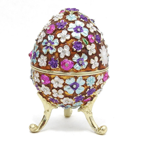 Shimmering Flowers Egg Box. A kaleidoscope of flowers in the Russian style. Translucent colors highlight the many colors enhanced with strategically placed Austrian crystals. The enamel is baked onto a pewter base and the stand is attached to the egg. The box has a magnetic fastener to secure the closure. Makes a wonderful gift and can used to store small jewelry. Comes in a satin-lined presentation box. Shimmering Flowers Egg Box. A kaleidoscope of flowers in the Russian style. Translucent colors highlight the many colors enhanced with strategically placed Austrian crystals. The enamel is baked onto a pewter base and the stand is attached to the egg. The box has a magnetic fastener to secure the closure. Makes a wonderful gift and can used to store small jewelry. Comes in a satin-lined presentation box.