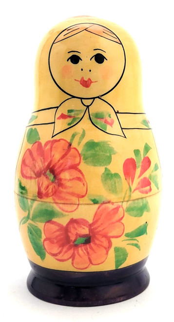 Kirov Purple Matryoshka, 8nest [1979]. Scarce color arrangement of an 8pc Kirov doll, circa 1977. This matryoshka set was made nearly 50 years ago, some 20 years after the formation of the production center itself. Any nesting dolls from the last quarter of the 20th century are somewhat scarce in about fine, unplayed with condition. Of note here is the continuation of the color purple dresses of the first three pieces, and one more near the end. The lines are sharp, as are the features, on the first four pieces, and the expressions are somber. The flowers, dots and swirls are numerous. The pieces all fit well. There is some age-related wear at the opening, but this can be color touched, if desired (we haven't). This is a highly collectible, 49 year-old set in about fine condition. 5⅝" down to tiny. The label reads (in part): Производственное объединение "Вятка" по выпуску игрушек г. Киров (Production association "Vyatka" for the production of toys, city of Kirov), plus a state mandated price, an article number and the export date (Oct 1983).  It's not easy to find information on how the Russian toy, specifically the Matryoshka doll, came to be the number one tourist and export item of the USSR era. The Russian, aka Soviet, toy production began courting the tourist trade in earnest sometime in the 1960s, when it encouraged small collectives and factories to produce souvenirs to be sold to non-Russians. It started slowly, but eventually built up speed as the Moscow 1980s Olympics was slated to welcome foreign, specifically from Europe and the West (aka USA), tourists. Interest in Russian handicrafts was also stoked by importers of said goods in the US and elsewhere.