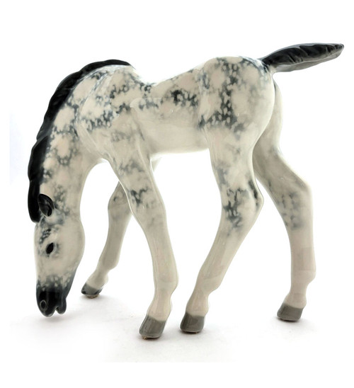 Dapple Gray Foal Lomonosov Porcelain. Also known as Pastured Colt. A vintage horse sculpture that was designed by Boris Yakovlevich Vorobiev (1911-1990), who was associated with the Lomonosov Porcelain Factory (LFZ) beginning in 1936 and ending in about 1980 due to illness. Hand painted hard paste porcelain in about new condition (small mark on the underside is a "release" mark incurred in the factory). 9⅝" x 3⅛" x 7½"