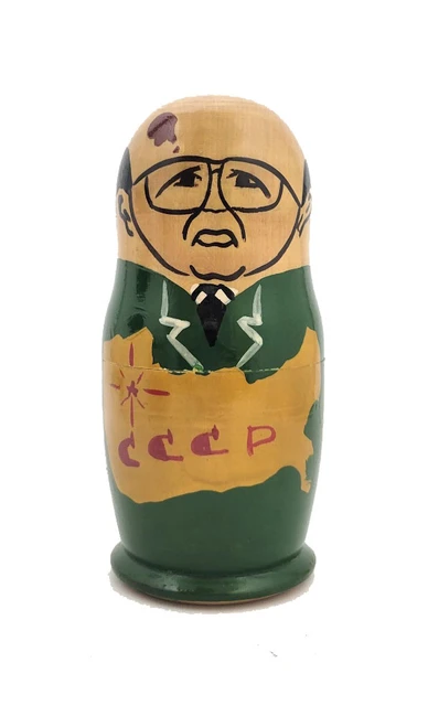 Gorbachev with Old Communist Leaders. This set appears to be an early one in the lineage of Gorbachev, aka, political nesting dolls. The anonymous artist has tackled his or her representation of the former Soviet leaders by simplifying and caricaturing them. The approach is somewhat demure, and the choice of colors is unusual. Mikhail Gorbachev is wearing a green suit with a large map of the USSR in yellow. Leonid Brezhnev wears a brown suit with stars and ribbons signifying his importance. Khrushchev is in Ukrainian peasant yellow covered by green corn stalks  Stalin is in blue and Lenin in dark brown. Most of the the early "Gorby" (an mildly affectionate name for "Gorbachev") dolls were made by talented amateurs in the Soviet Union. Mikhail Gorbachev transformed the USSR by unleashing a pair of political, and cultural, waves. The first was "Гласность" (Glasnost, i.e, openness) and "Перестройка" (Perestroika, i.e., rebuilding). These shock waves led to unrestrained freedom of expression. This set leading off with Gorbachev indicates that it was made before 1991, before Yeltsin was elected, and Gorbachev demoted to second place.