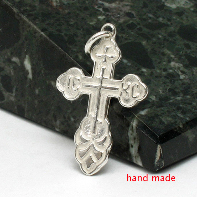 St. Olga Sterling Silver Russian Orthodox Cross. Traditional high-relief design. The initials for Jesus Christ, IC XC, and a descending dove, symbolizing the Holy Spirit. With the short prayer on the back: "Спаси и Сохрани" (Save and Protect). 1" (25mm) Sterling silver, cast by hand in small batches using the lost wax method. Elegantly gift boxed. St. Olga Sterling Silver Russian Orthodox Cross. Traditional high-relief design. The initials for Jesus Christ, IC XC, and a descending dove, symbolizing the Holy Spirit. With the short prayer on the back: "Спаси и Сохрани" (Save and Protect). 1" (25mm) Sterling silver, cast by hand in small batches using the lost wax method. Elegantly gift boxed.