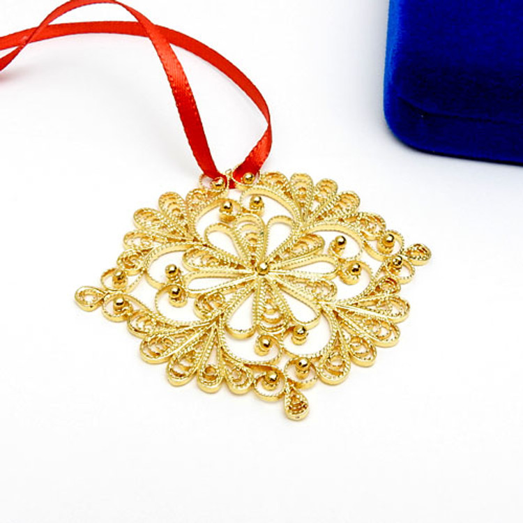 Snowflake (Снежинка) Ornament. Pure silver over copper. Gold plated. An exquisite Christmas ornament "spun" by hand in the village of Kazakovo. The original design was created by master artist Antonina Varlova, to evoke the charm and beauty of a delicate snowflake.