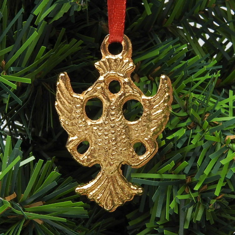 Solid brass and gold plate casting of the Byzantine double-headed eagle. Hang it on your Christmas tree with the attached red ribbon. 1¾" height.