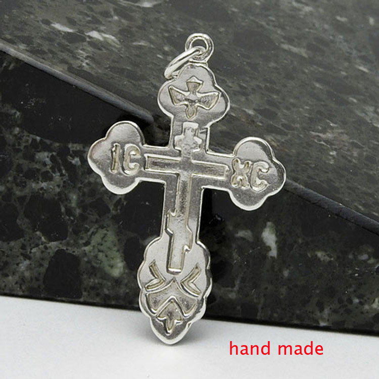 Sterling Silver Orthodox Cross. An elegant and traditional design. Symbols include IC XC, the initials for Jesus Christ, and a descending dove, symbolizing the Holy Spirit.  1¼" (33mm) Sturdy (not thin), hand cast in small quantities using the lost wax method. Gift boxed.
