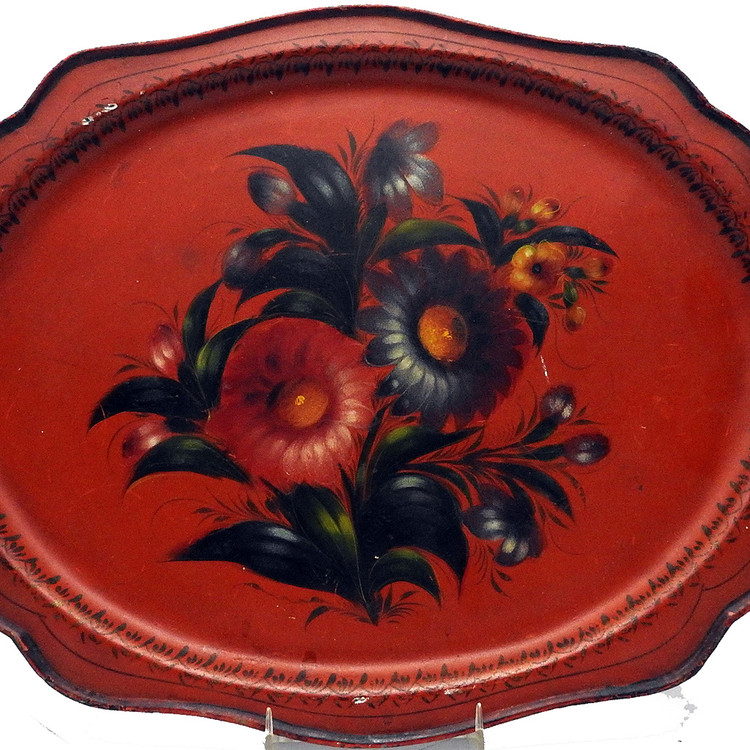 Antique Painted Tray "Bouquet on red background". Zhostovo Work Artel, circa 1930. Painted flowers on a tin tray. The history of Zhostovo arts and crafts (Жостовская роспись) dates back to the early 19th century. Its roots align with painted lacquered objects on papier-mache and Ural Tagil flower painting, which appeared earlier in the 18th century. In 1922 «Novosel'tsevo work artel» was founded in Novosel'tsevo in the Podmoskovye region, which made lacquered metal trays. In 1924 "Zhostovo work artel" and "Spetskustar" were also founded there and in 1925 two more, "Lakirovshik" and "Svoy trud". In 1925, all of them were combined into one artel "Metallopodnos". Today, it is named The Zhostovo Factory of Decorative Painting (Жостовская фабрика декоративной росписи).  Marked "Made in the Soviet Union" in white lettering at the bottom of the back of the tray.