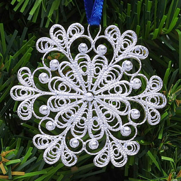 Snowflake (Снежинка) Ornament. An exquisite Christmas ornament "spun" by hand in the village of Kazakovo. The original design was created by master artist Antonina Varlova, to evoke the charm and beauty of a delicate snowflake. Pure silver over copper.