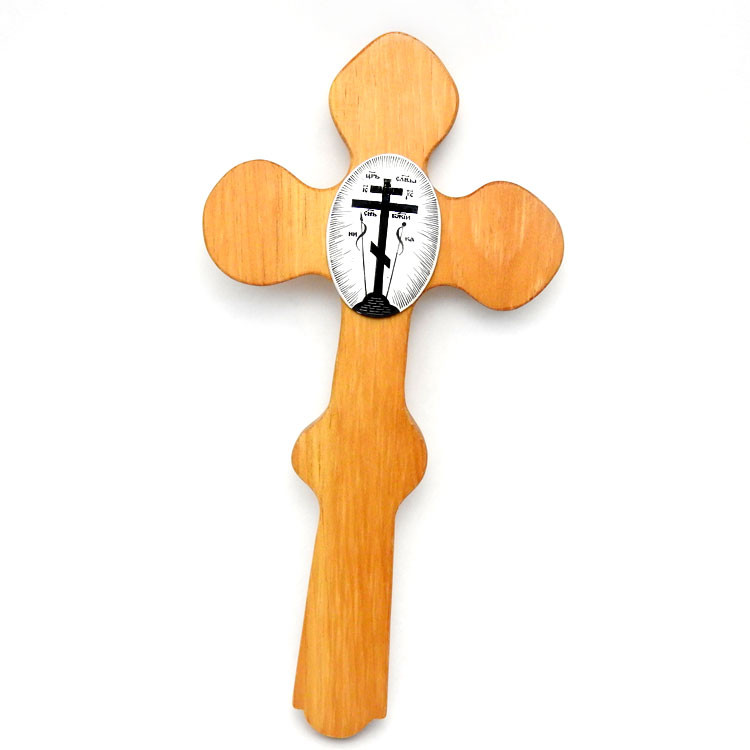 Orthodox Wall Cross. Elegant lacquered and finished pine wood inset with a painted papier-mache oval medallion depicting the Russian cross rising from the Mount of Golgotha. Surrounding it are the Instruments of the Passion, accompanied by inscriptions in Slavonic and bathed in a glittering depiction of glory.
