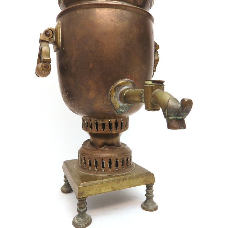 Pre-revolutionary small brass samovar. An unusual addition to a samovar collection. Hand made, probably Tula - see the array of nuts holding the knobs. In distressed, used condition. Theories abound for this one. 1) it might have been carried around for a quick boil of water to prepare one or two cups of tea, 2) it's part of a child's tea set, and 3) it was a salesman's sample.