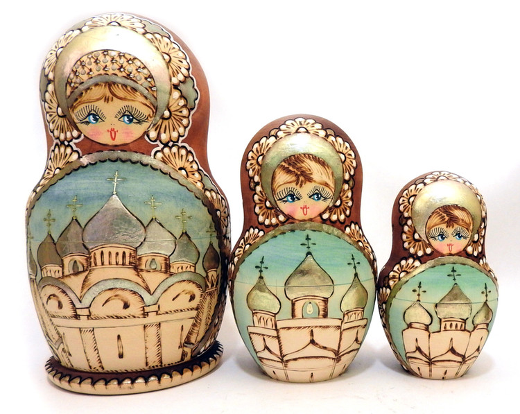 Churches of Bogorodsk. Detailed woodburnt designs go to the last tiny doll as well as the painting and enhancements, including "potal" gold and silver foil decoration (the foil is called potal) that imitates gilding and silvering. The centers of each piece also have blue sky behind each of the silver cupolas and the maiden enhancements include silver headdresses, lacework and fan designs, plus strategically place small dots.