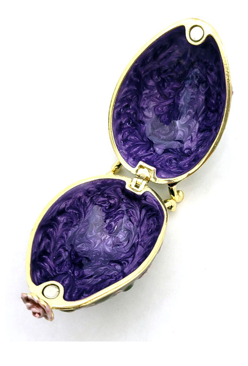 Purple Roses Floral Box. Delicate purple/white roses intertwined with green leaf tendrils on a hand enameled purple background. This egg box evokes the style of Peter Carl Faberge, court jeweler to the Russian Tsars. The enamel is baked onto a pewter base, then polished and finally set with genuine Austrian crystals. The egg is hinged and can store small jewelry. Comes in a satin-lined gift box.