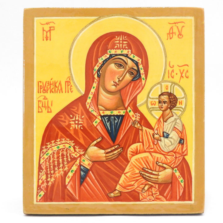The Mother of God of Georgia is a revered icon of the Hodegetria Virgin Mary. It holds great significance in the Georgian Orthodox Church and is venerated as the country's protector. The original icon was taken from Georgia (Sakartvelo) to Persia in 1622 and later came to the Chernogorsky (Krasnogorsky) Monastery in Russia in 1629. This icon is often the Panagia Portaitissa, located at the Iviron monastery on Mount Athos.  The Mother of God Hodegetria literally means "She who shows the way." The Mother of God is depicted holding the Child Jesus as She points to Him as the source of salvation for mankind. She is the source of grace to those looking for God. The scroll refers to the descent of the Holy Spirit.