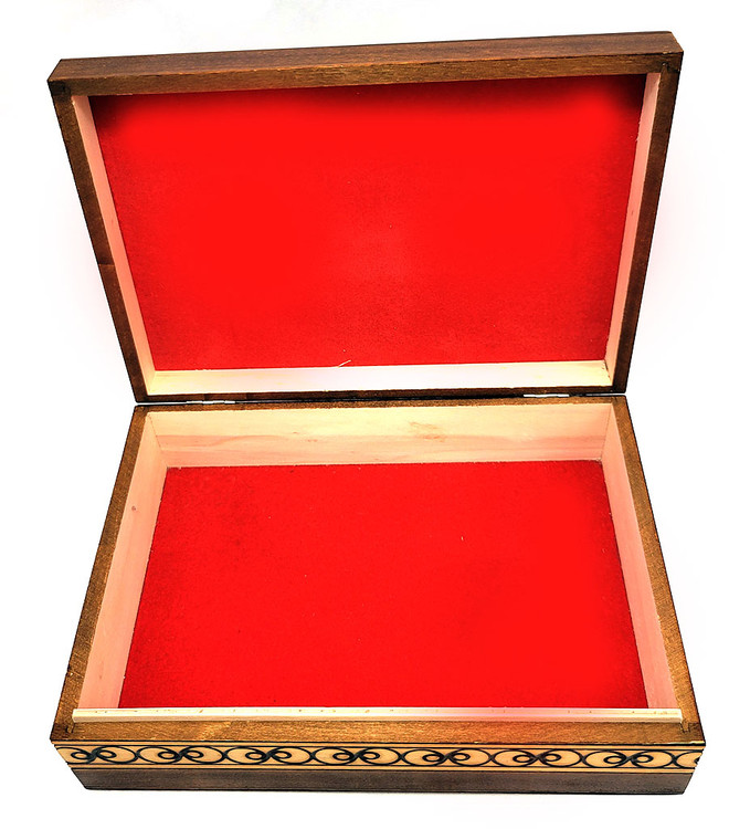 Set of 5 nested wooden Polish boxes. Crafted in Zakopane (Podhale region), a town which lies at the foothills of the Tatra Mountains. Each box is identically carved and stained with decorations incised using the techniques of the craft of traditional pyrography (woodburning). Boxes are lined with bright red felt (a nice touch), and nest perfectly within one another. The center of each box is a spiral flower with red and green enhancements and the surrounding wood is intricately textured. Three largest boxes have elaborate edge borders. An unusual set in brand new condition.