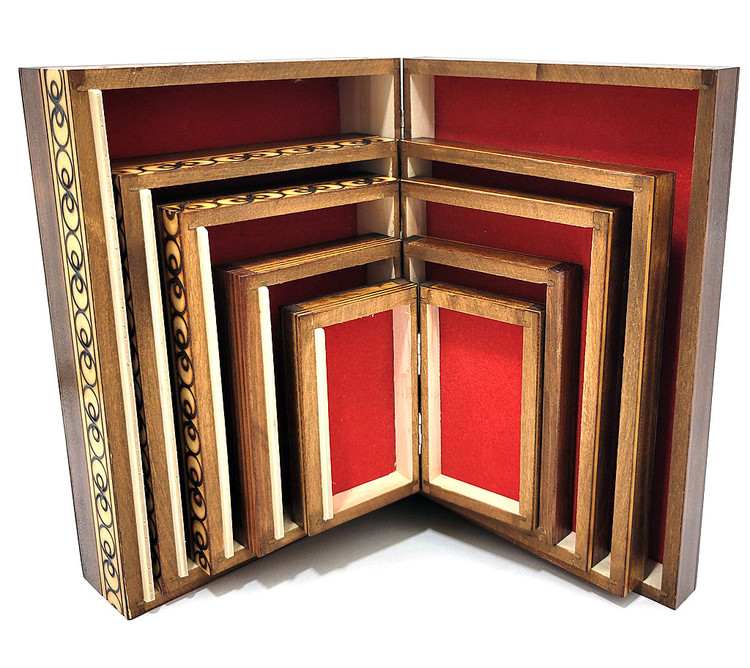 Set of 5 nested wooden Polish boxes. Crafted in Zakopane (Podhale region), a town which lies at the foothills of the Tatra Mountains. Each box is identically carved and stained with decorations incised using the techniques of the craft of traditional pyrography (woodburning). Boxes are lined with bright red felt (a nice touch), and nest perfectly within one another. The center of each box is a spiral flower with red and green enhancements and the surrounding wood is intricately textured. Three largest boxes have elaborate edge borders. An unusual set in brand new condition.