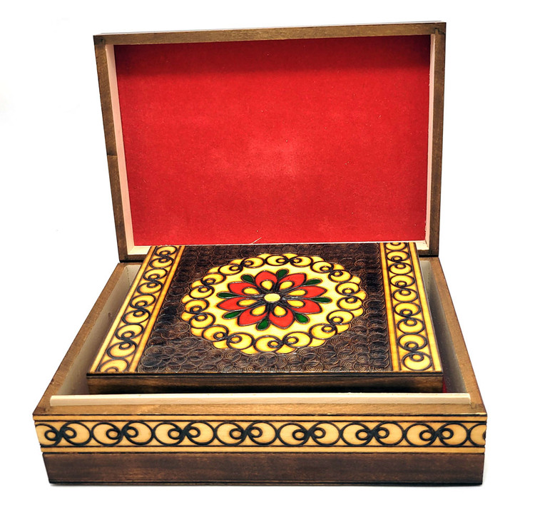 Set of 5 nested wooden Polish boxes. Crafted in Zakopane (Podhale region), a town which lies at the foothills of the Tatra Mountains. Each box is identically carved and stained with decorations incised using the techniques of the craft of traditional pyrography (woodburning). Boxes are lined with bright red felt (a nice touch), and nest perfectly within one another. The center of each box is a spiral flower with red and green enhancements and the surrounding wood is intricately textured. Three largest boxes have elaborate edge borders. An unusual set in brand new condition.